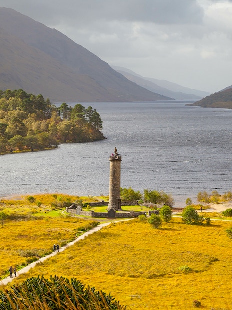 Glenfinnan Monument overlooking Loch Shiel with surrounding hills in Scotland.
