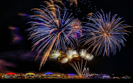 Fireworks display over Chicago Navy Pier at night.