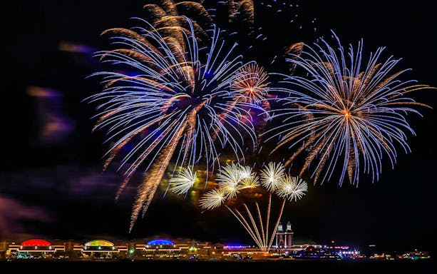 Fireworks display over Chicago Navy Pier at night.