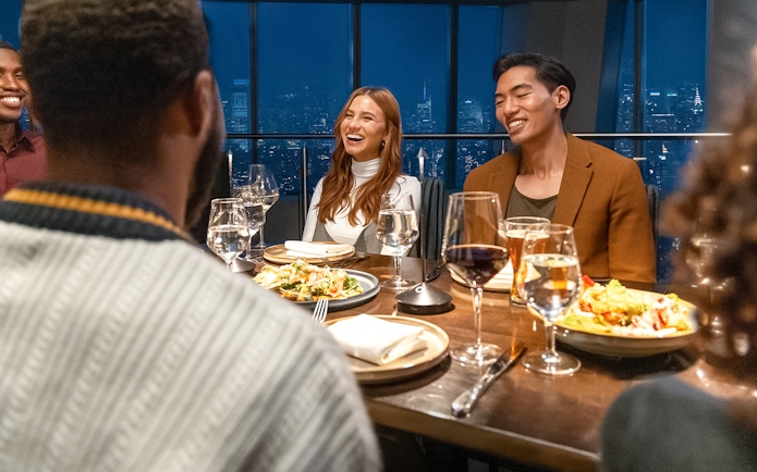 Dining experience at One World Observatory with city skyline view.