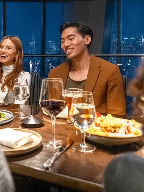 Dining experience at One World Observatory with city skyline view.