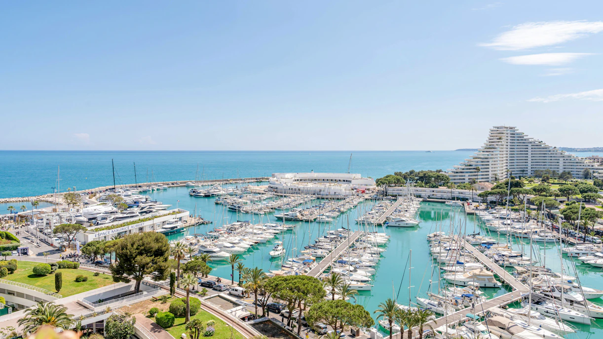 Aerial view of Marina Baie des Anges, Villeneuve-Loubet with yachts, turquoise water, and pyramid buildings.