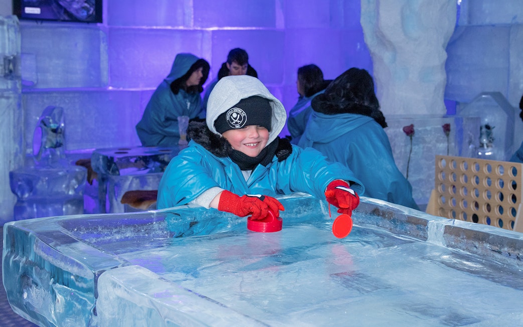 Child playing at ice table in IceBar Surfers Paradise.