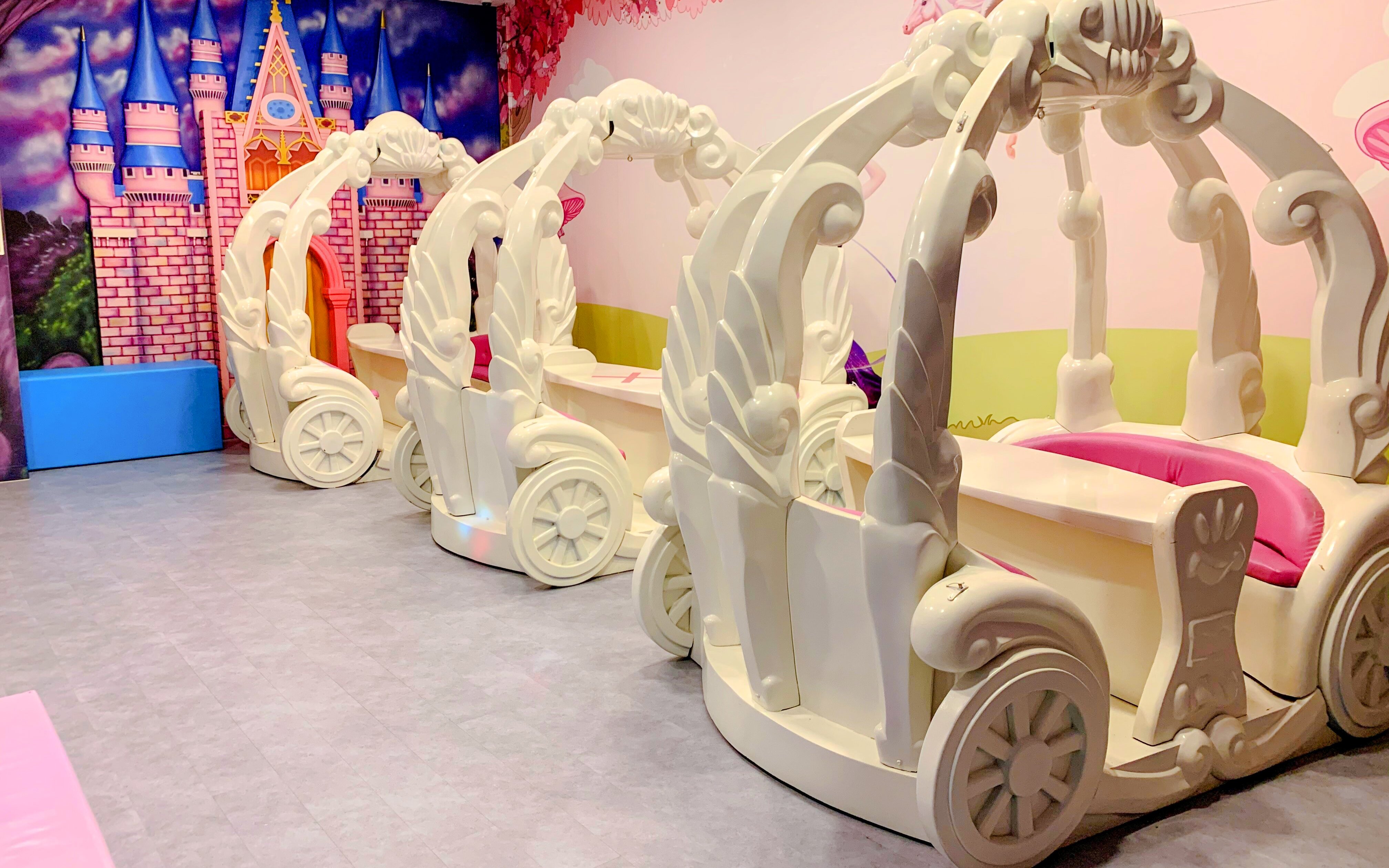 Indoor play area with carriage-themed seating at Amazonia Singapore.