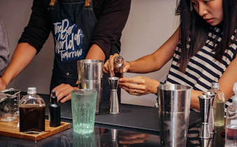 Preparing coffee-themed cocktails in a Vietnamese mixology class.