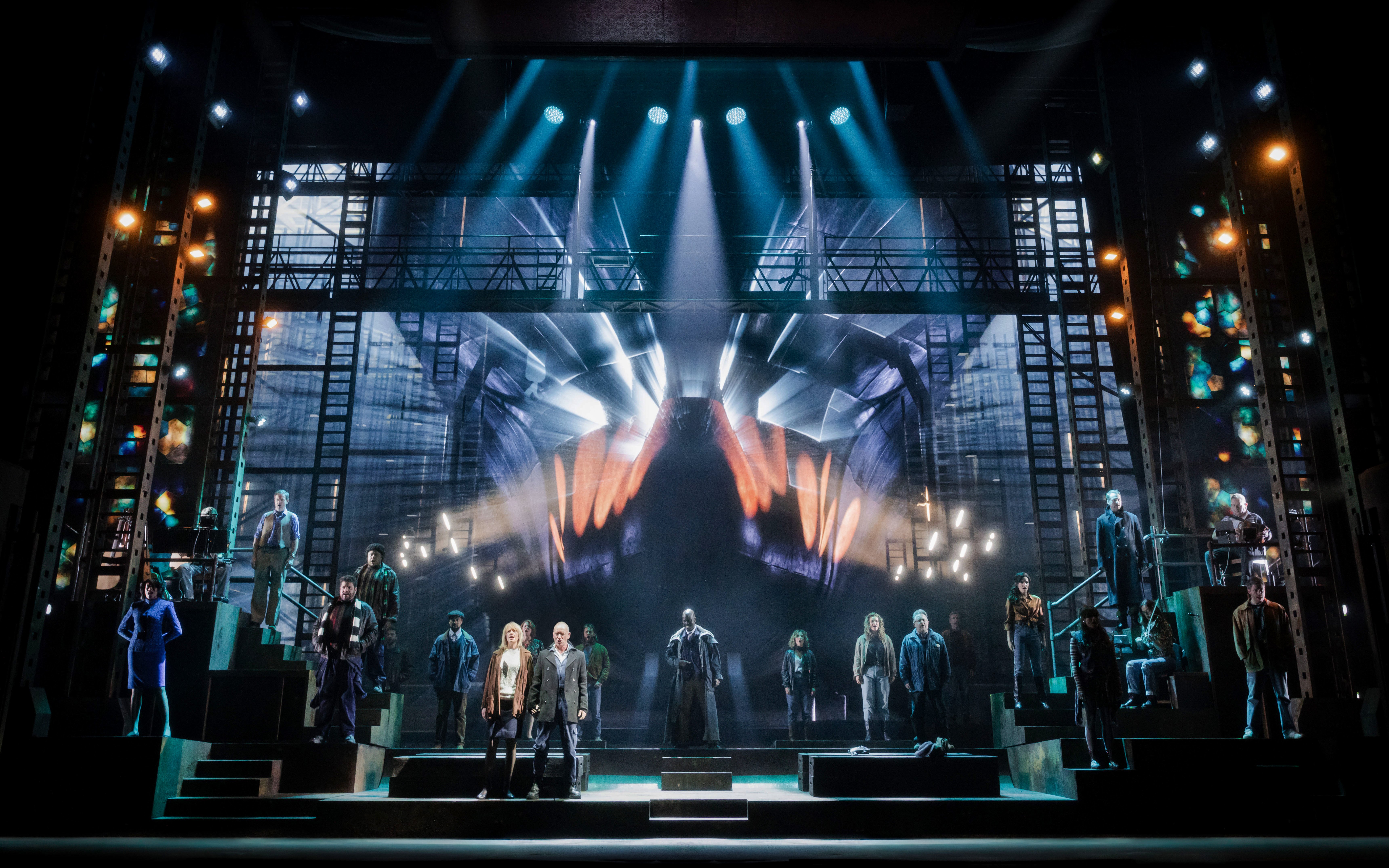 Stage performance of "The Last Ship" in Brisbane with cast on illuminated set.