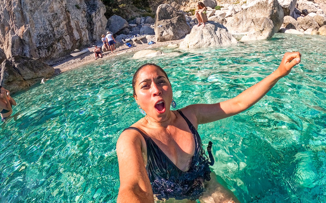 Person enjoying clear waters during a kayak tour in Capri, Italy.