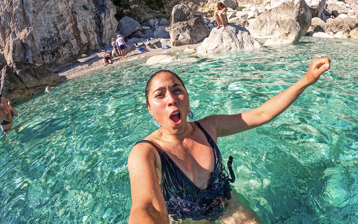 Person enjoying clear waters during a kayak tour in Capri, Italy.