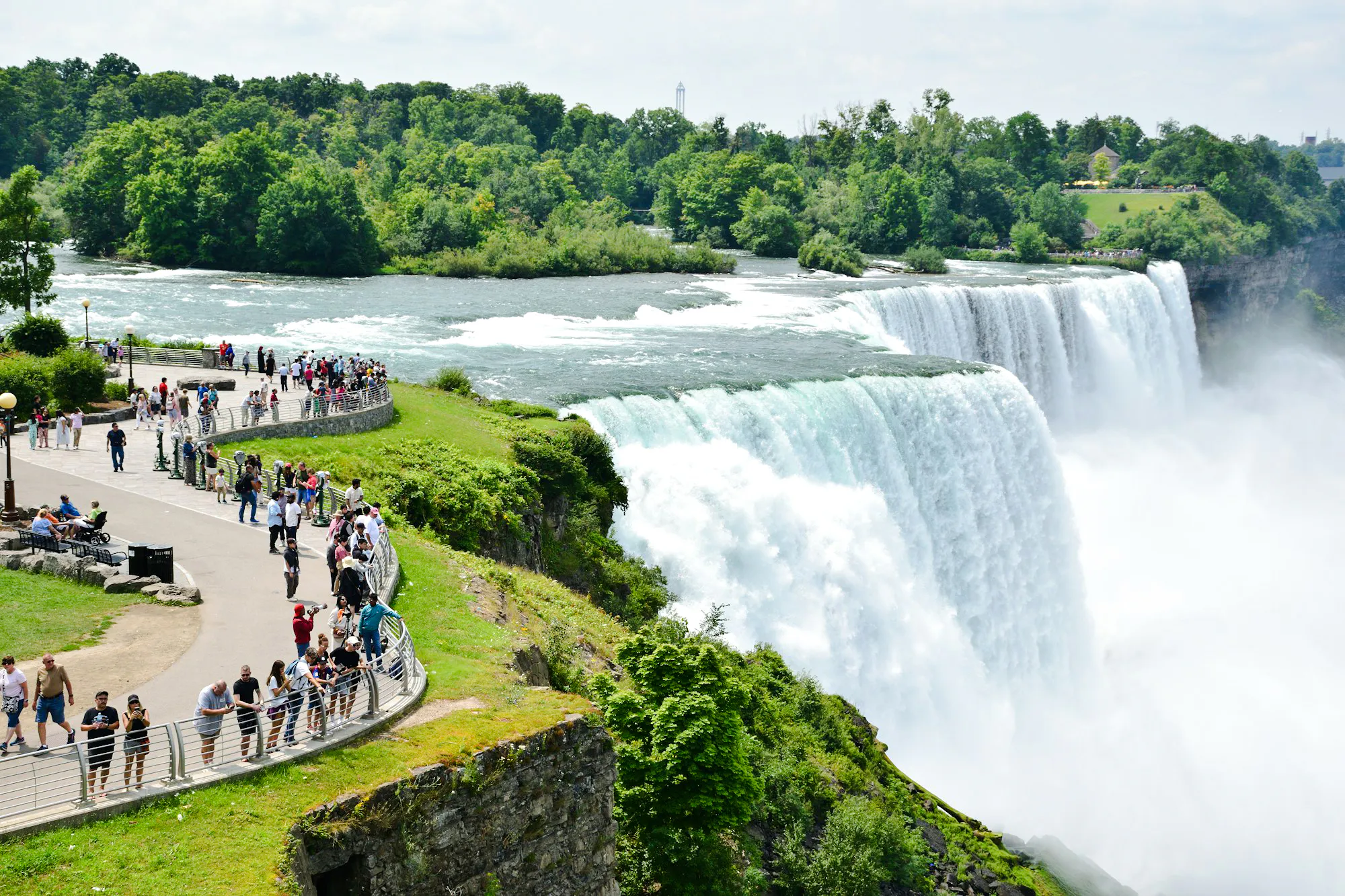 Visitors viewing Niagara Falls from a scenic walkway, Niagara Falls, Canada.
