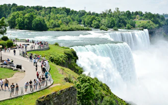 Visitors viewing Niagara Falls from a scenic walkway, Niagara Falls, Canada.
