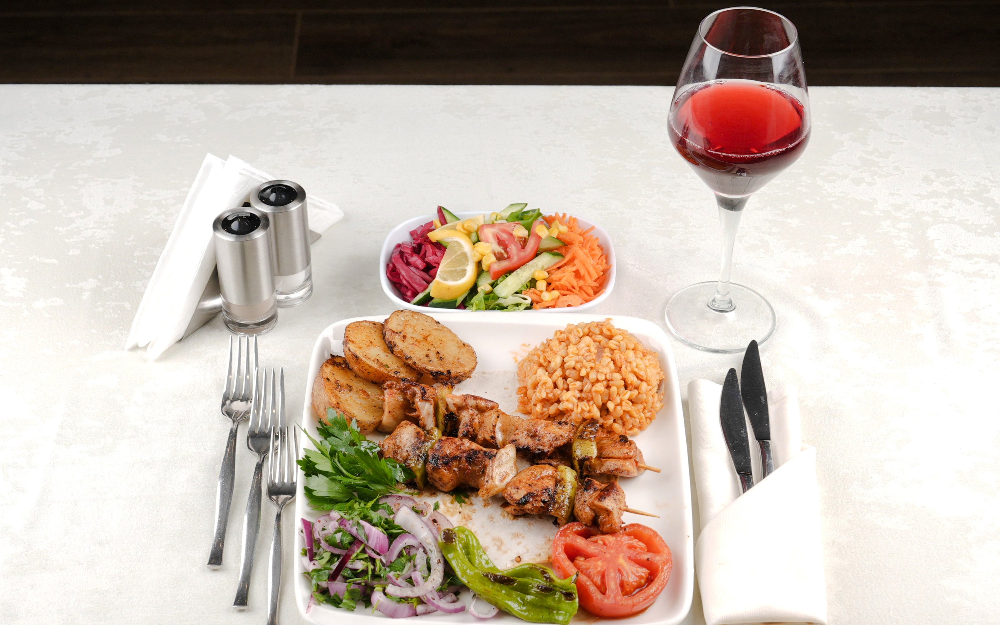 Grilled kebabs with rice, salad, and wine on Bosphorus Lunch Cruise.