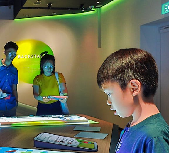 Child interacting with digital exhibit at Petrosains Discovery Centre.