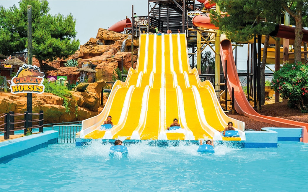 Visitors enjoying the Crazy Horses water slide at Western Water Park.
