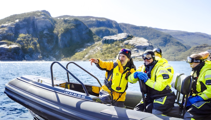 RIB boat on Lysefjord Safari with guide and guests exploring Norwegian fjord.