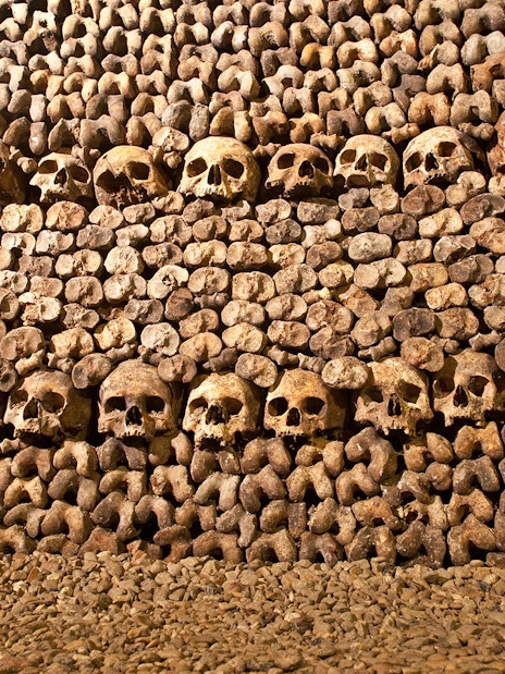 Skulls and bones arranged in the Paris Catacombs.