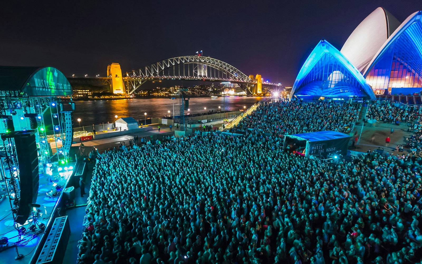 Crowd at a concert in the Forecourt of the Sydney Opera House with Harbour Bridge in the background.
