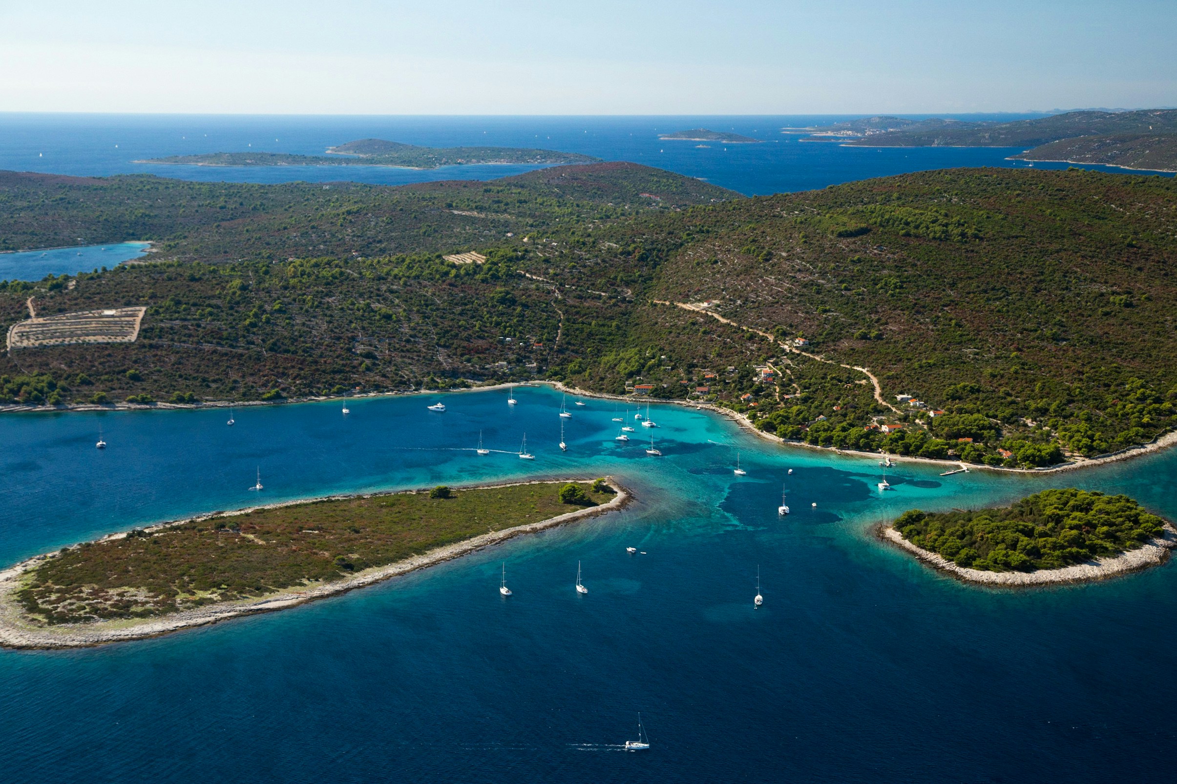 Aerial view of Drvenik Veli island with sailboats in the Adriatic Sea, Croatia.