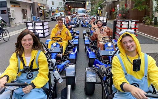 People in costumes driving go-karts on Asakusa Street during GoKart Experience in Tokyo.