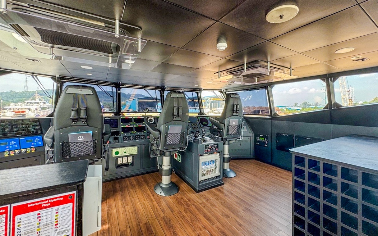 Ferry cockpit interior on Singapore to Bintan route with control panels and seating.