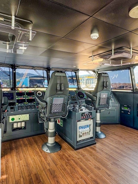 Ferry cockpit interior on Singapore to Bintan route with control panels and seating.