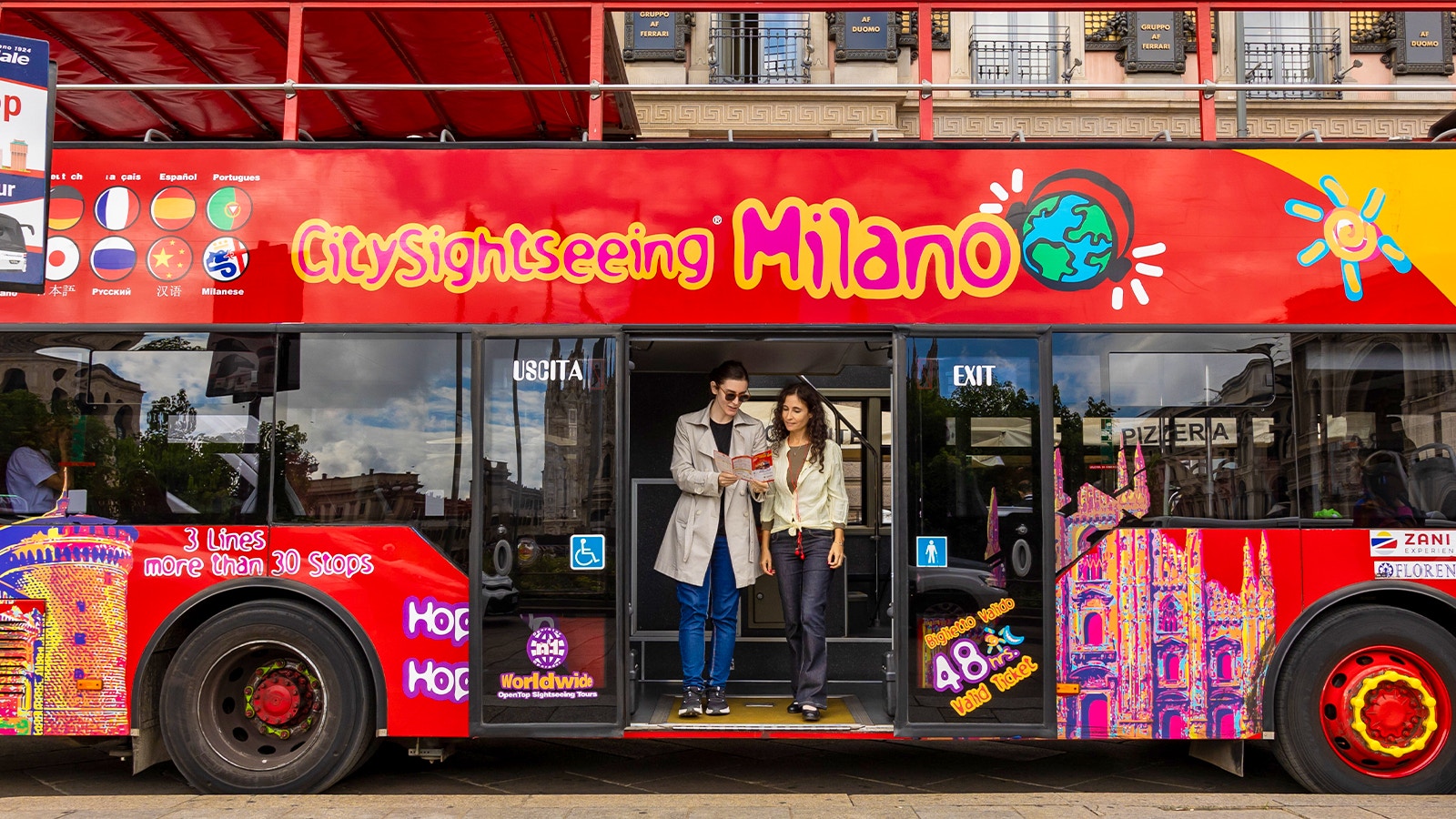 Milan hop-on hop-off bus passing by the Duomo Cathedral.