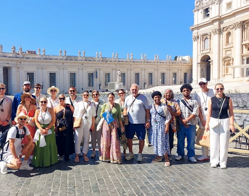 Small group exploring St. Peter's Basilica interior on guided tour, Vatican City.