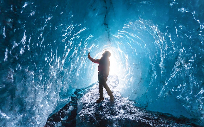 Guest exploring inside Blue Ice Cave, Vatnajökull, Iceland.