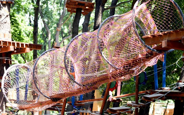 Rope tunnel in the trees at Paradis Land adventure park.
