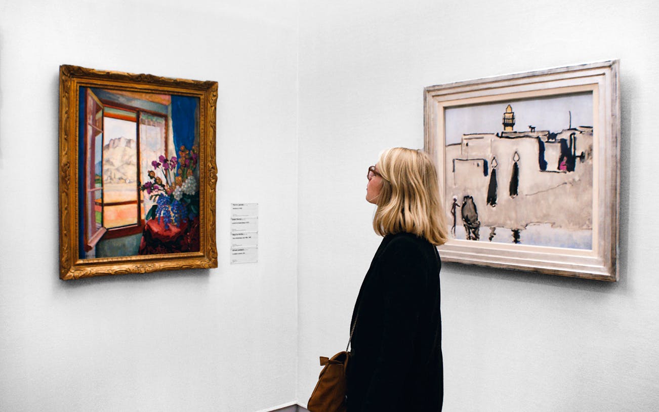 Female tourist viewing paintings at Centre Pompidou, Paris.