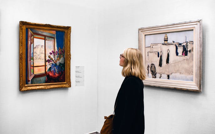 Female tourist viewing paintings at Centre Pompidou, Paris.