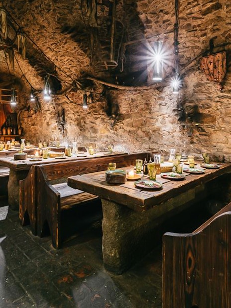 Medieval dining hall setup for a three-course dinner in Prague.