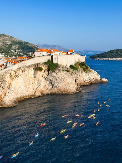 Kayakers near Old Town Walls on a coastal tour.
