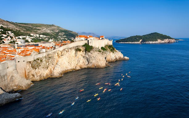 Kayakers near Old Town Walls on a coastal tour.