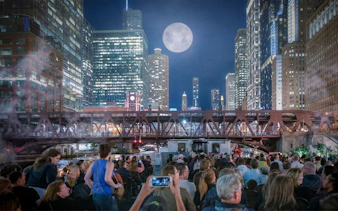 Crowd on Chicago Haunted River "Creepy Cruise" by First Lady under moonlit skyline.