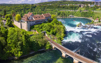 Aerial view of Schloss Laufen Castle overlooking Rhine Falls in Switzerland.