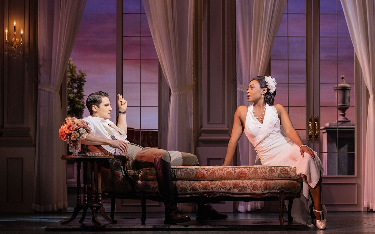 Two actors in 1920s attire on stage during a scene from The Great Gatsby.