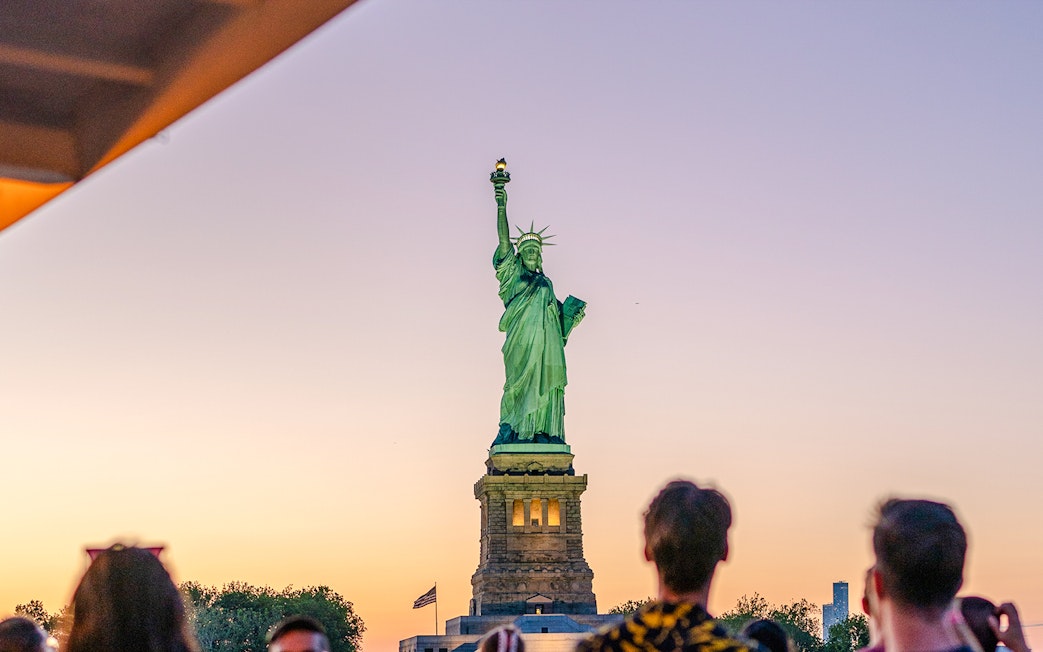 Statue of Liberty at sunset viewed from Circle Line cruise, New York City.