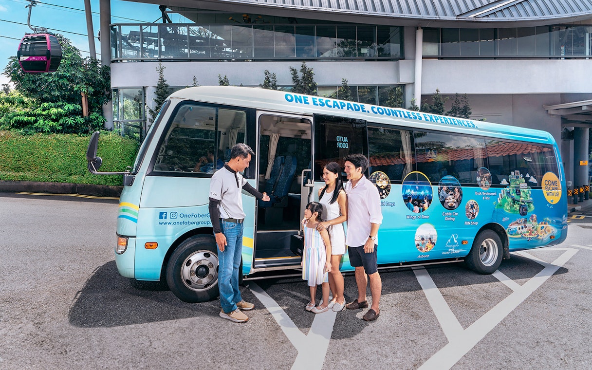Family boarding tour bus near Singapore Cable Car station.