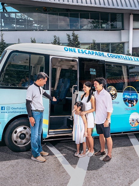 Family boarding tour bus near Singapore Cable Car station.