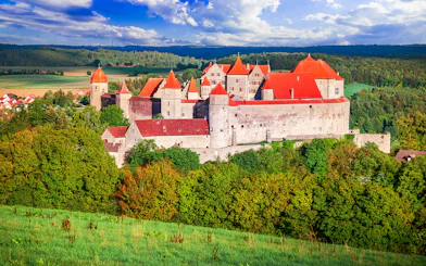 Harburg Castle with red roofs surrounded by lush greenery on the Romantic Road, Germany.