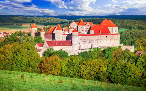 Harburg Castle with red roofs surrounded by lush greenery on the Romantic Road, Germany.