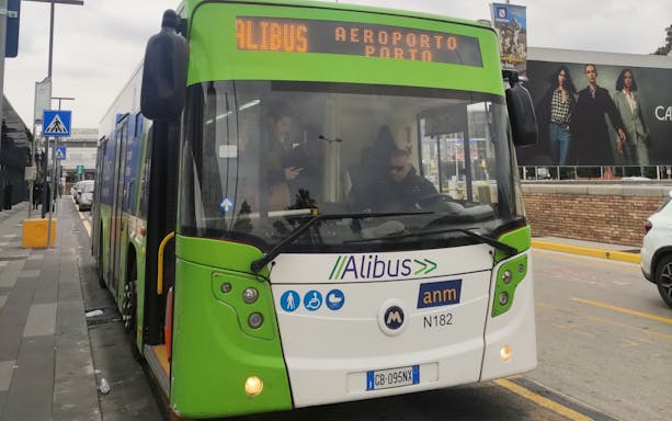 Alibus at Capodichino Airport bus stop, offering one-way tickets to Naples City Center.