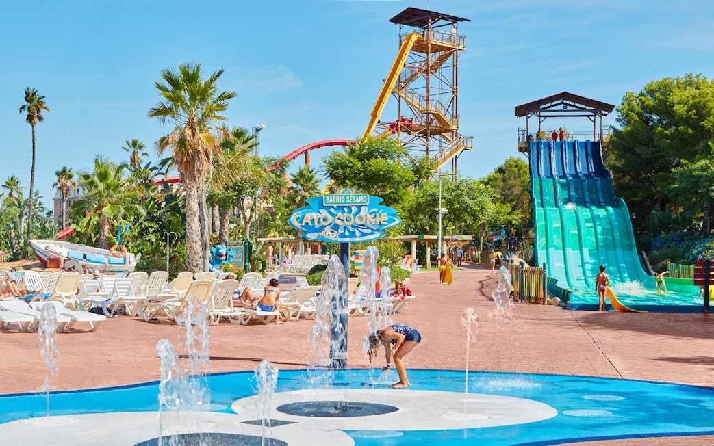 Children playing in splash area with water slides at Costa Caribe Aquatic Park.