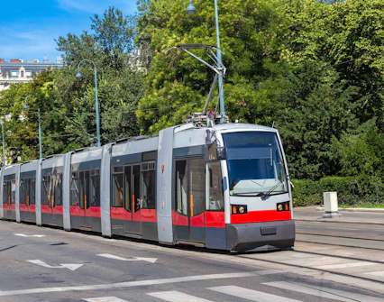 Vienna tram traveling through a tree-lined street.