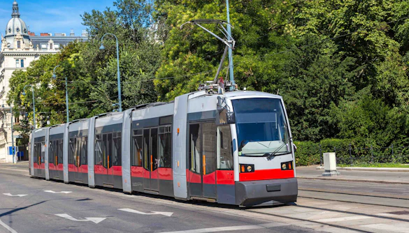 Vienna tram traveling through a tree-lined street.