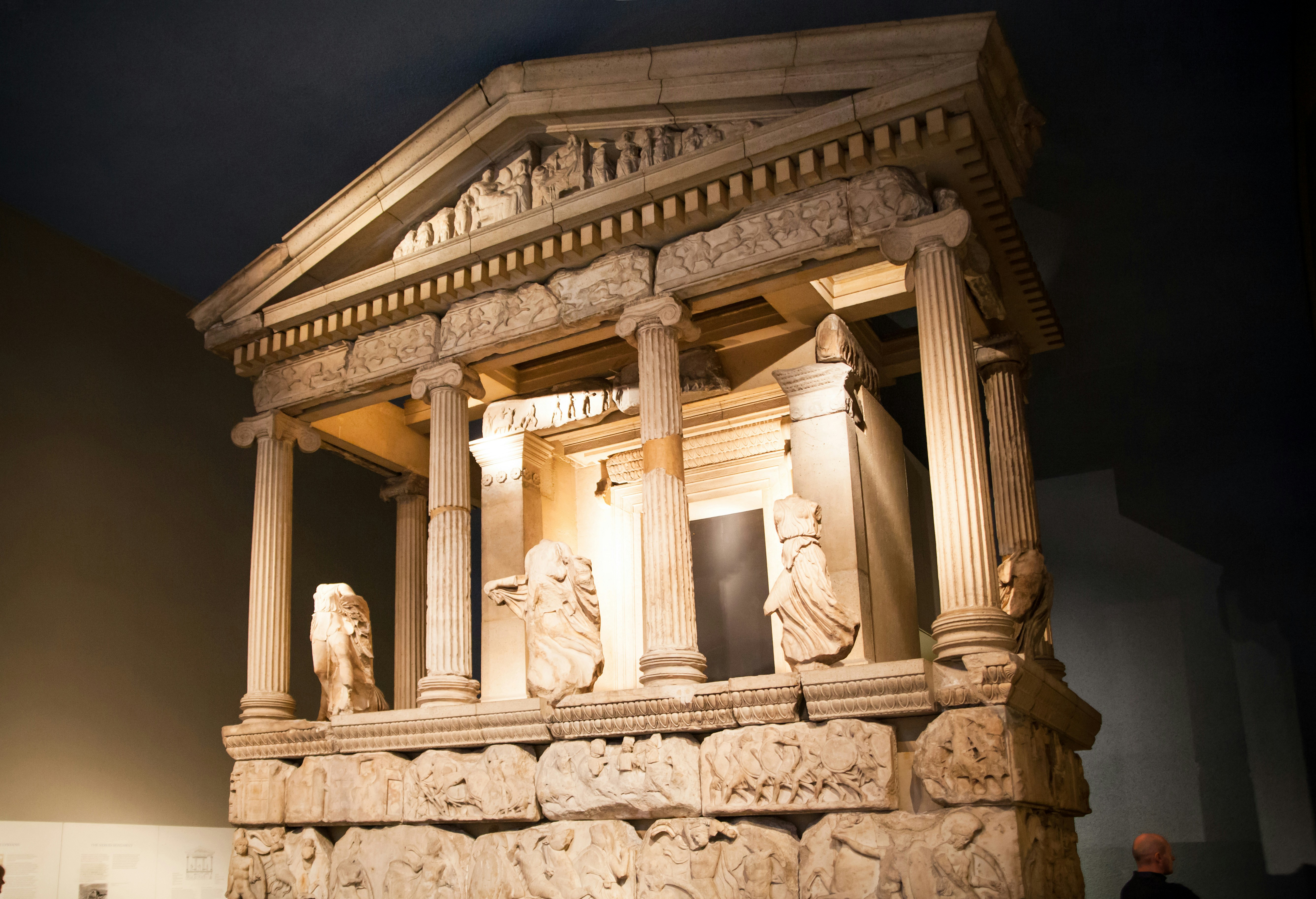 Ancient Greek temple facade with sculptures and columns at the British Museum.