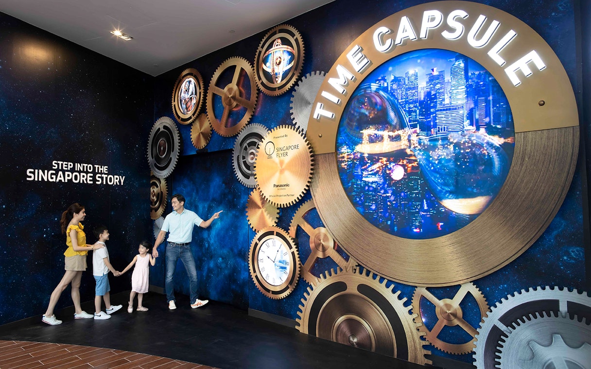 Family exploring the Time Capsule exhibit at Singapore Flyer.