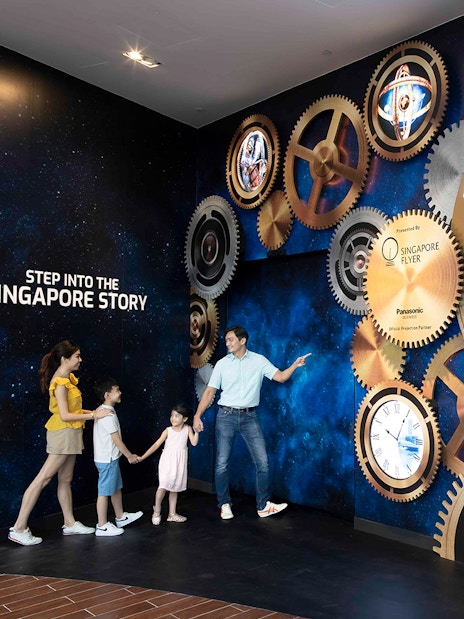 Family exploring the Time Capsule exhibit at Singapore Flyer.
