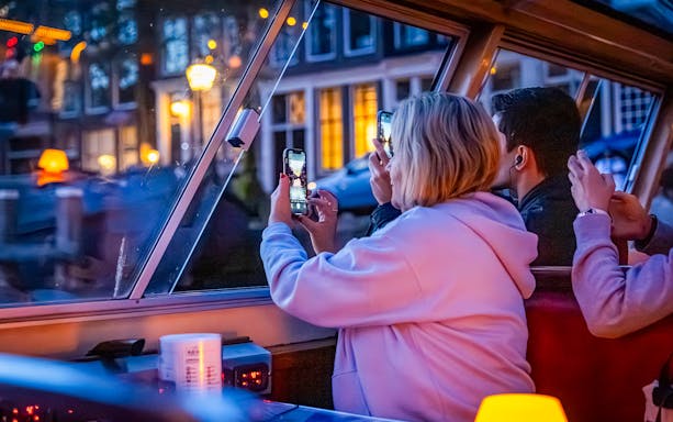 Guests capturing city lights on the Happy Valentine Evening Cruise.