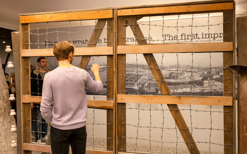Visitor examining exhibit at Oskar Schindler’s Factory in Krakow.